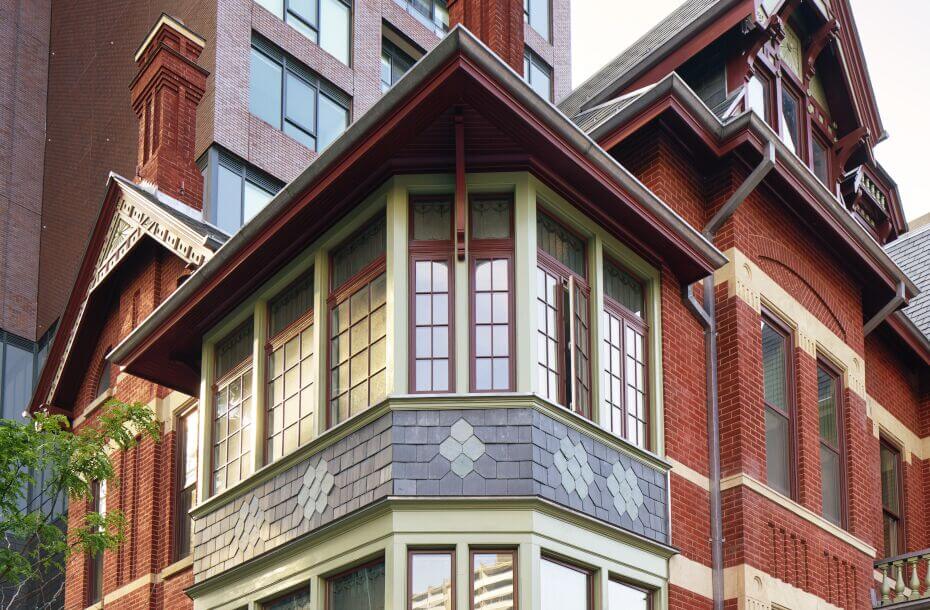 Detail of a beautiful red brick building with fine details on the windows and roofline